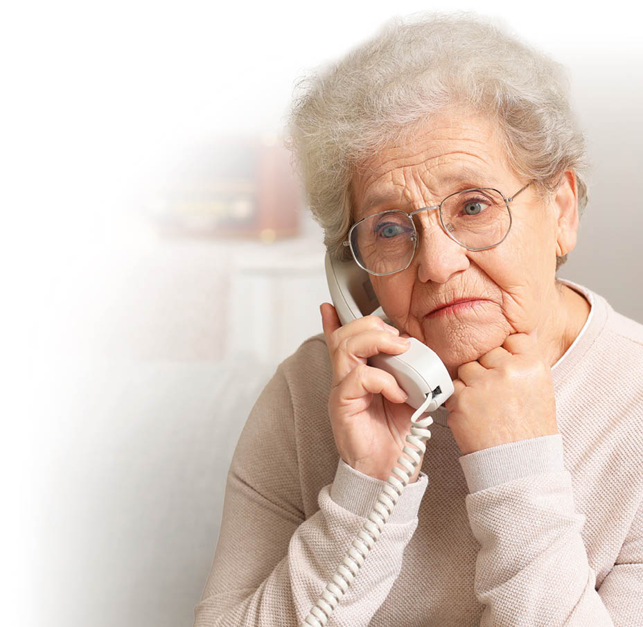 Senior woman talking by telephone at home, closeup
